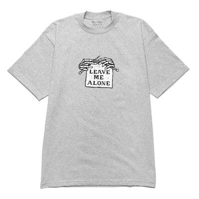 A grey t-shirt with a text design on the front chest and a tag indicating 'LEAVE ME ALONE'. The shirt is displayed on a white background.